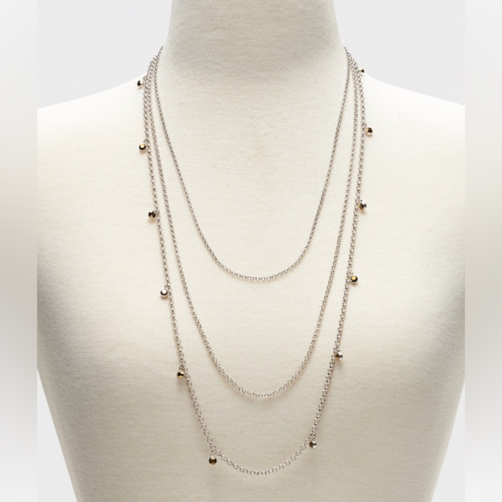 Multi-layer silver tone necklace with antique gold tone crystals